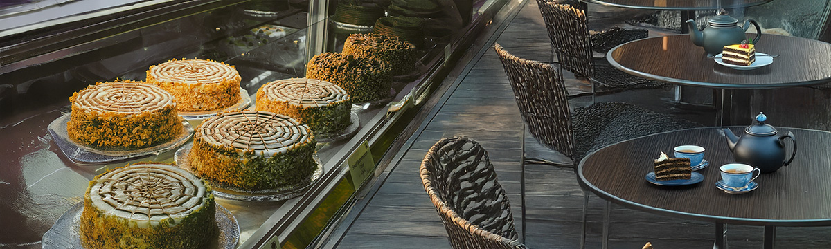 Interior of cafe showing cake display and seating area